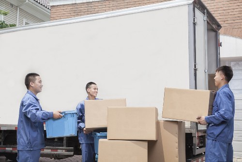 Careful loading of household items into a moving van in Islington