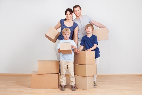 Professional movers handling furniture in an Islington property