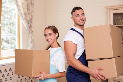 Professional movers organizing items inside a home relocation